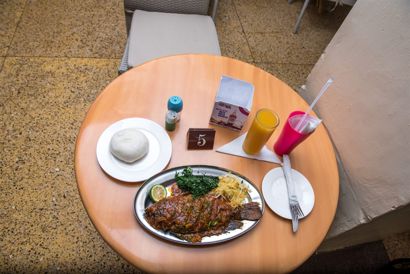 Whole fried tilapia served with ugali, sukuma wiki and kachumbari