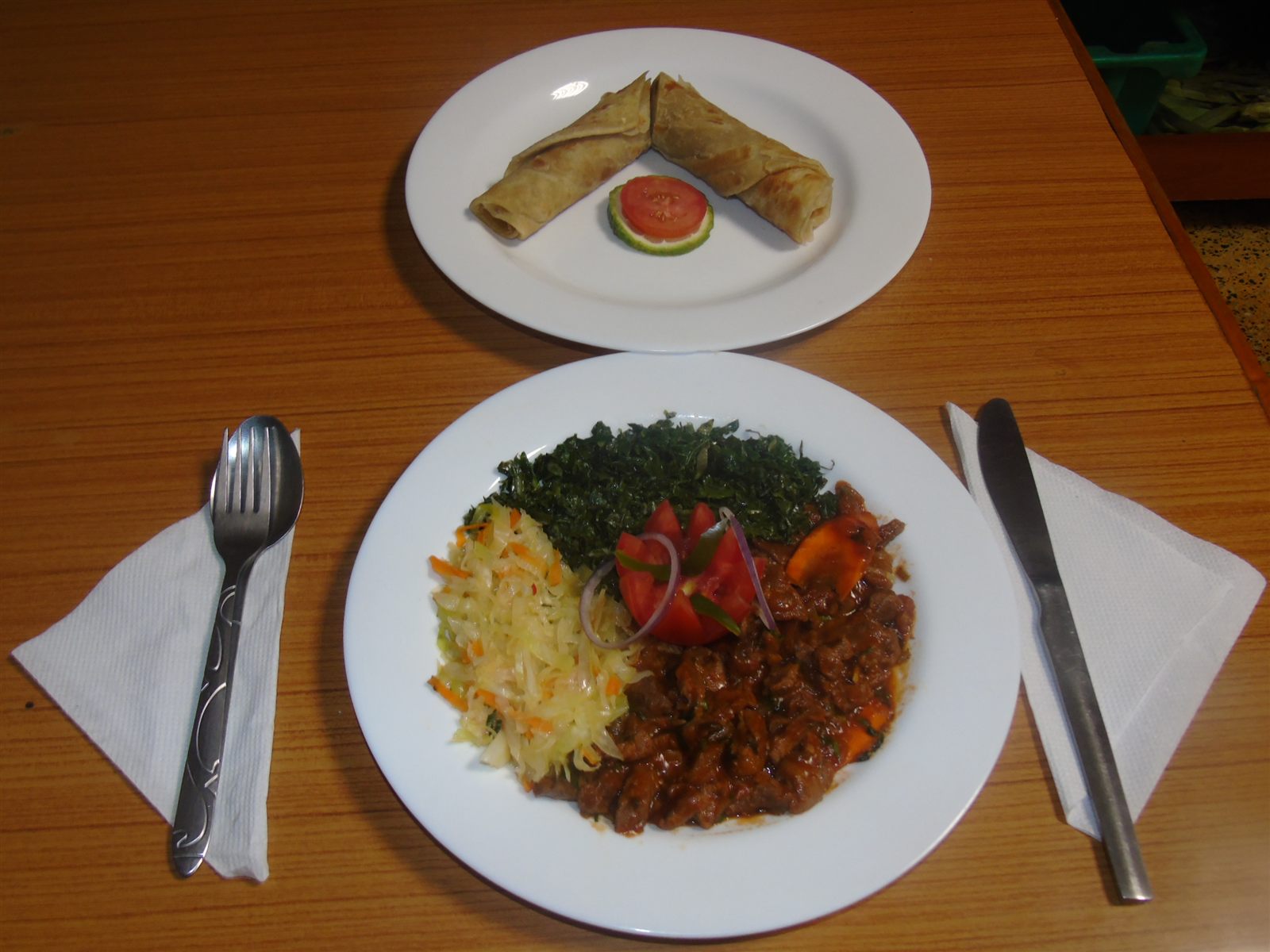 Kenyan plate of beef stew, sukuma wiki, cabbage and chapati