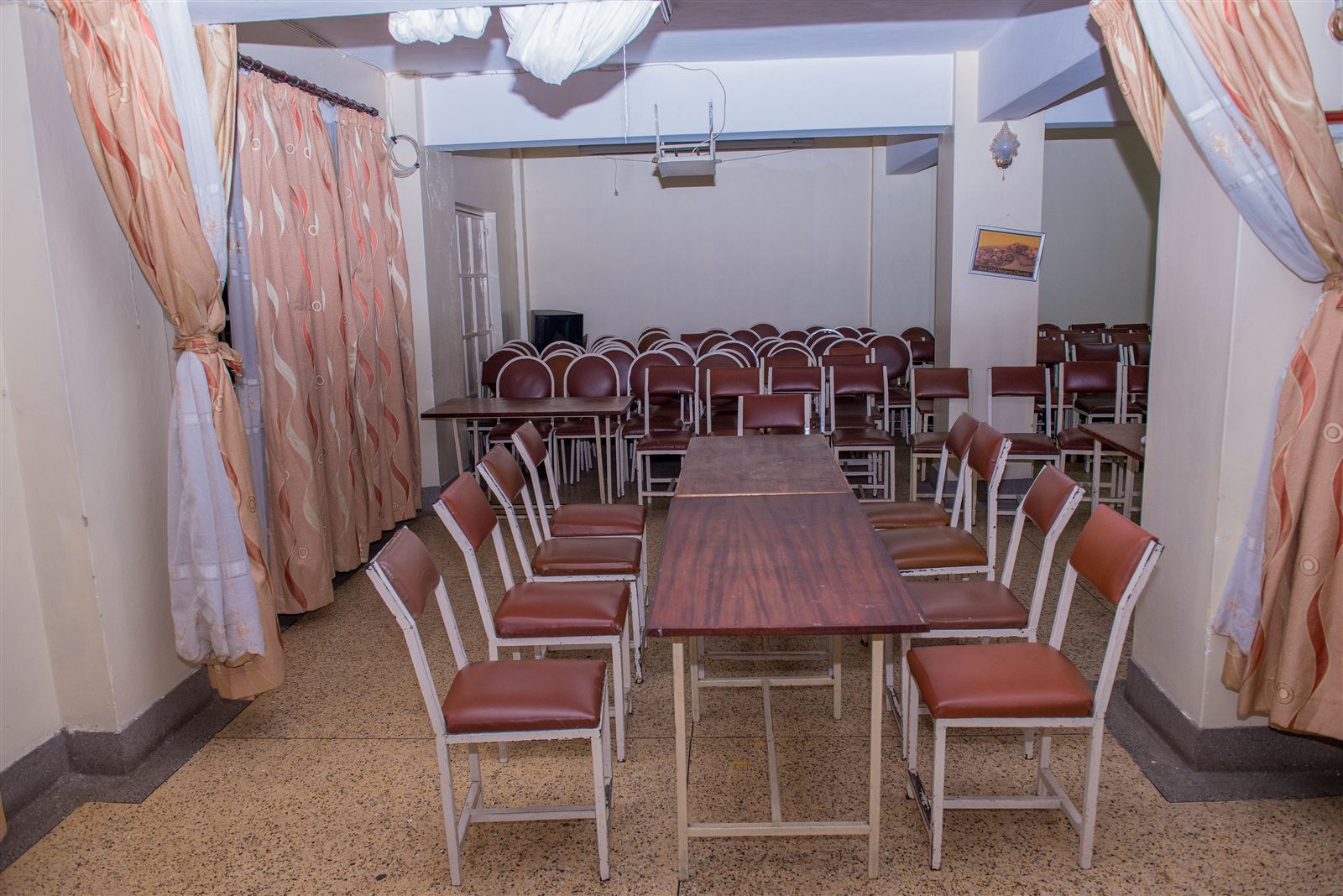 Conference hall set up with rows of chairs